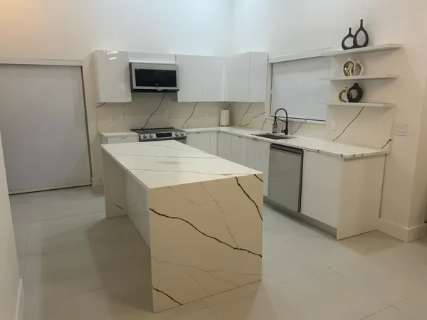 a kitchen with a sink cabinets and appliances