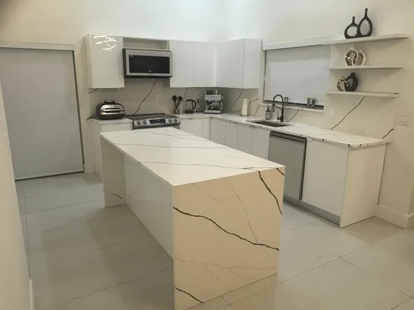 a kitchen with a sink a stove and cabinets