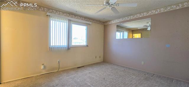 6313 Chippewa Road Colorado Springs, CO 80915 - Photo 34 of 36 Carpeted empty room with ceiling fan and a textured ceiling