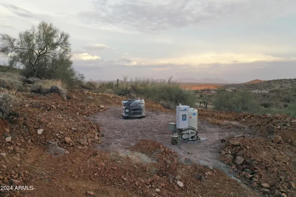 a view of a fire pit with large trees
