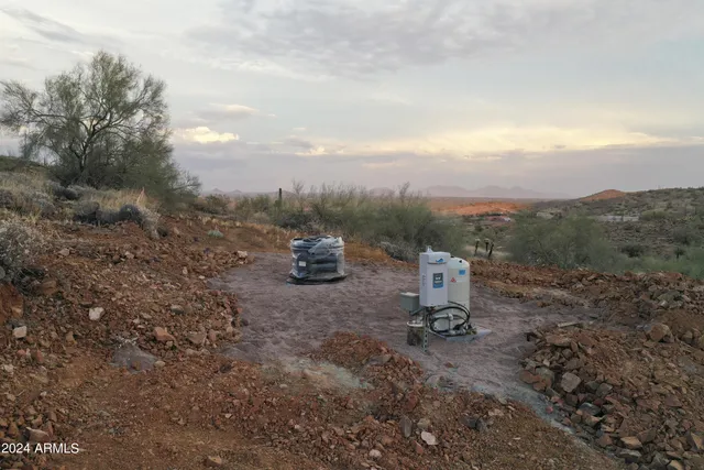 a view of a fire pit with large trees