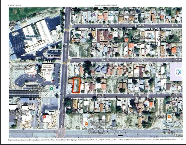 a view of a yard with wooden fence