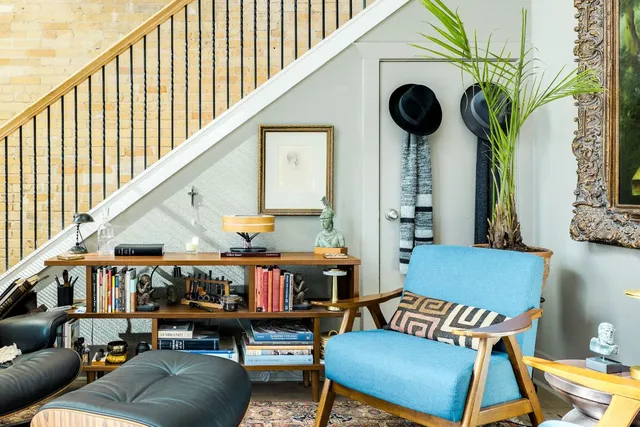 a living room with furniture and a potted plant