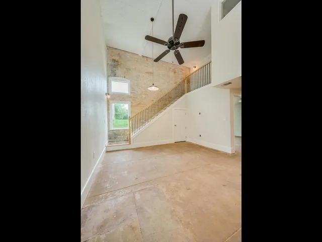 a view of a hallway with a ceiling fan