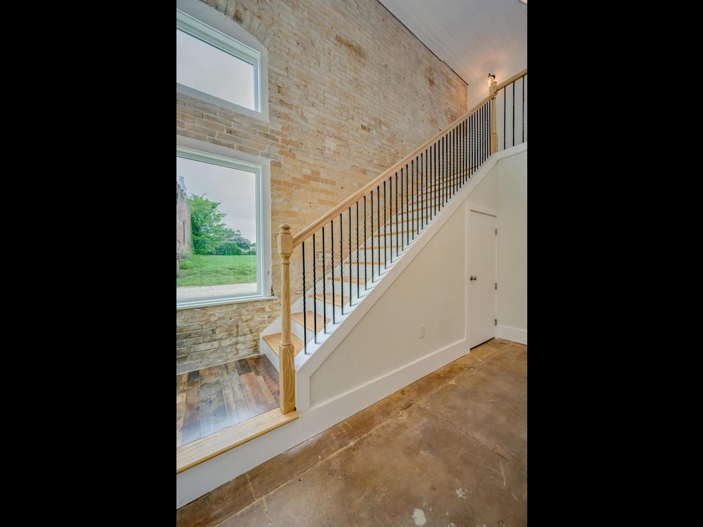 110 South Main Street, Unit 104 Elgin, TX 78621 - Photo 13 of 20 a view of a hallway with staircase