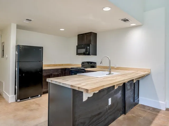 a kitchen with a sink and a refrigerator