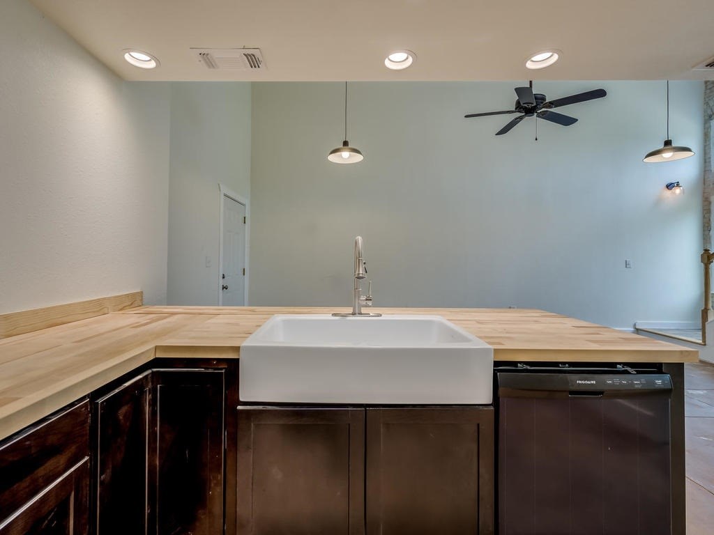 110 South Main Street, Unit 104 Elgin, TX 78621 - Photo 4 of 19 a sink with a table and chairs