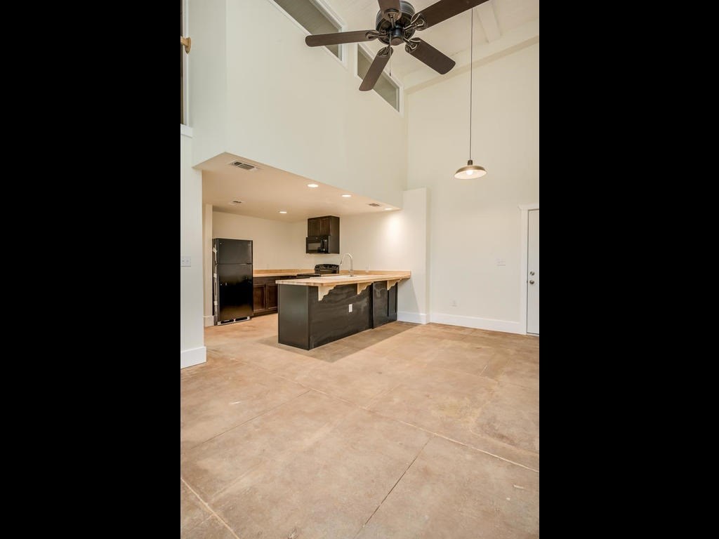 110 South Main Street, Unit 104 Elgin, TX 78621 - Photo 6 of 19 a view of a kitchen with a sink and a stove top oven