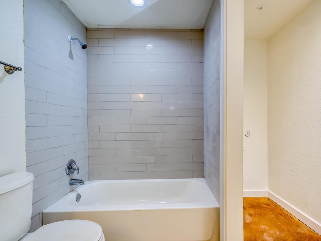 110 South Main Street, Unit 104 Elgin, TX 78621 - Photo 10 of 20 a bathroom with a bathtub and shower