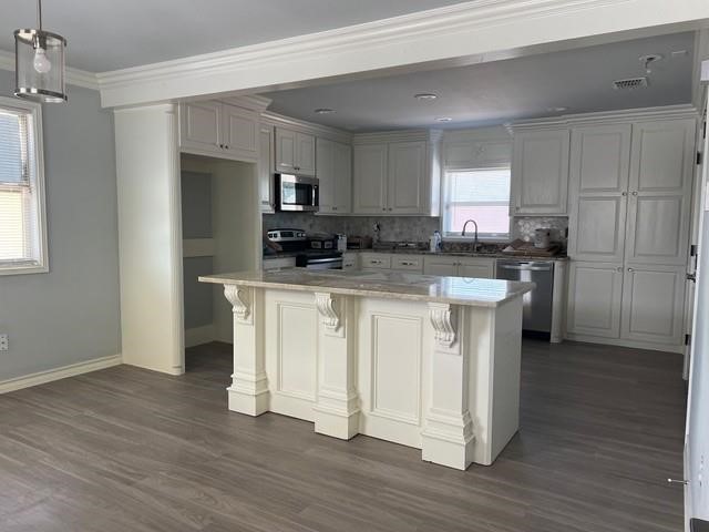 5375 County Road 73A, Unit 2 Robstown, TX 78380 - Photo 7 of 14 a kitchen with white cabinets and stainless steel appliances