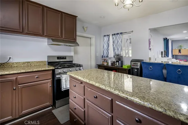a kitchen with granite countertop a sink and cabinets