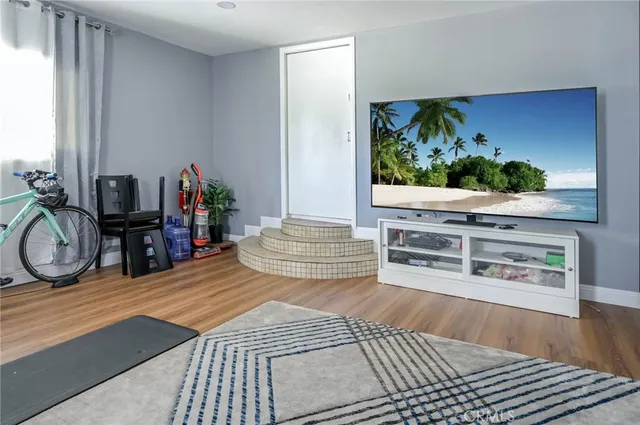 a bedroom with furniture and a flat screen tv