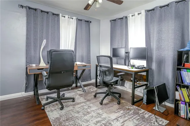 a view of a workspace with furniture and a window