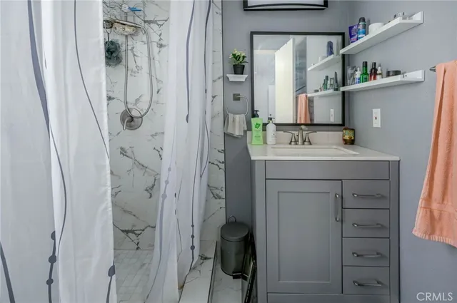 a bathroom with a sink vanity and mirror