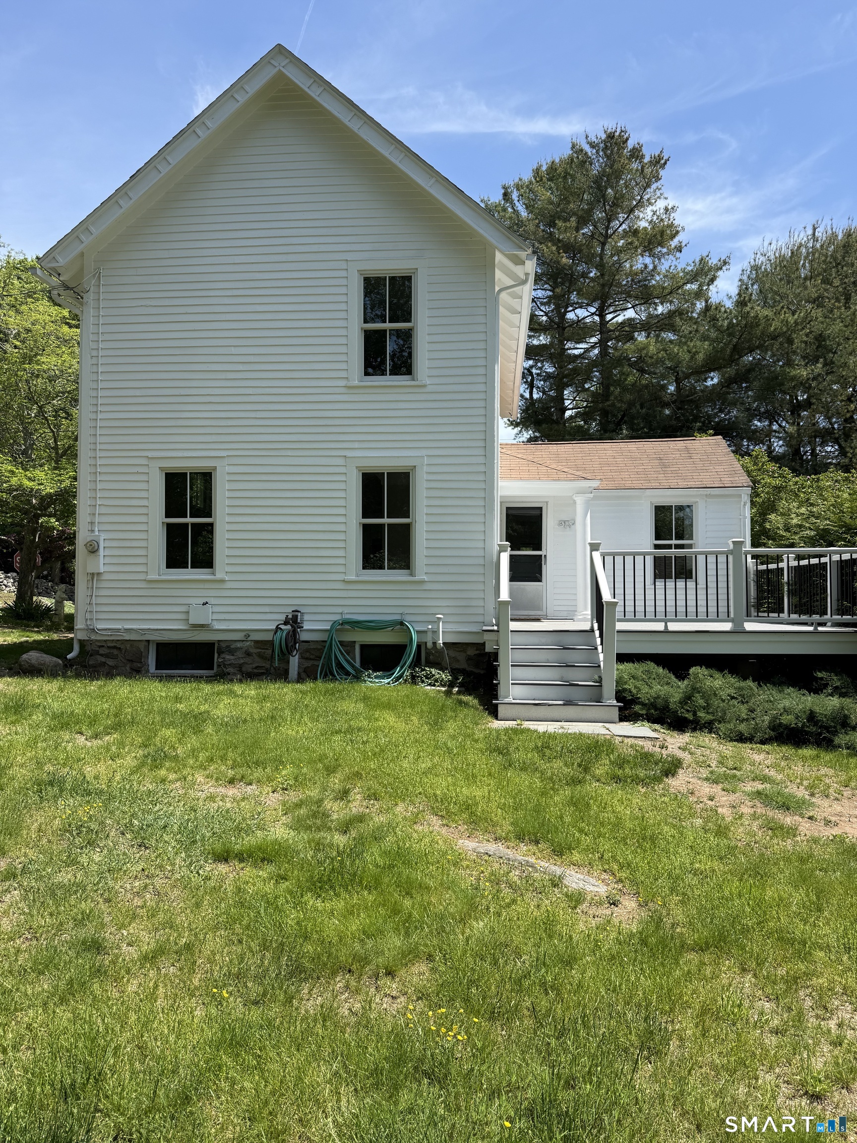 312 Ferry Road Old Lyme, CT 06371 - Photo 3 of 16 a house view with a garden space