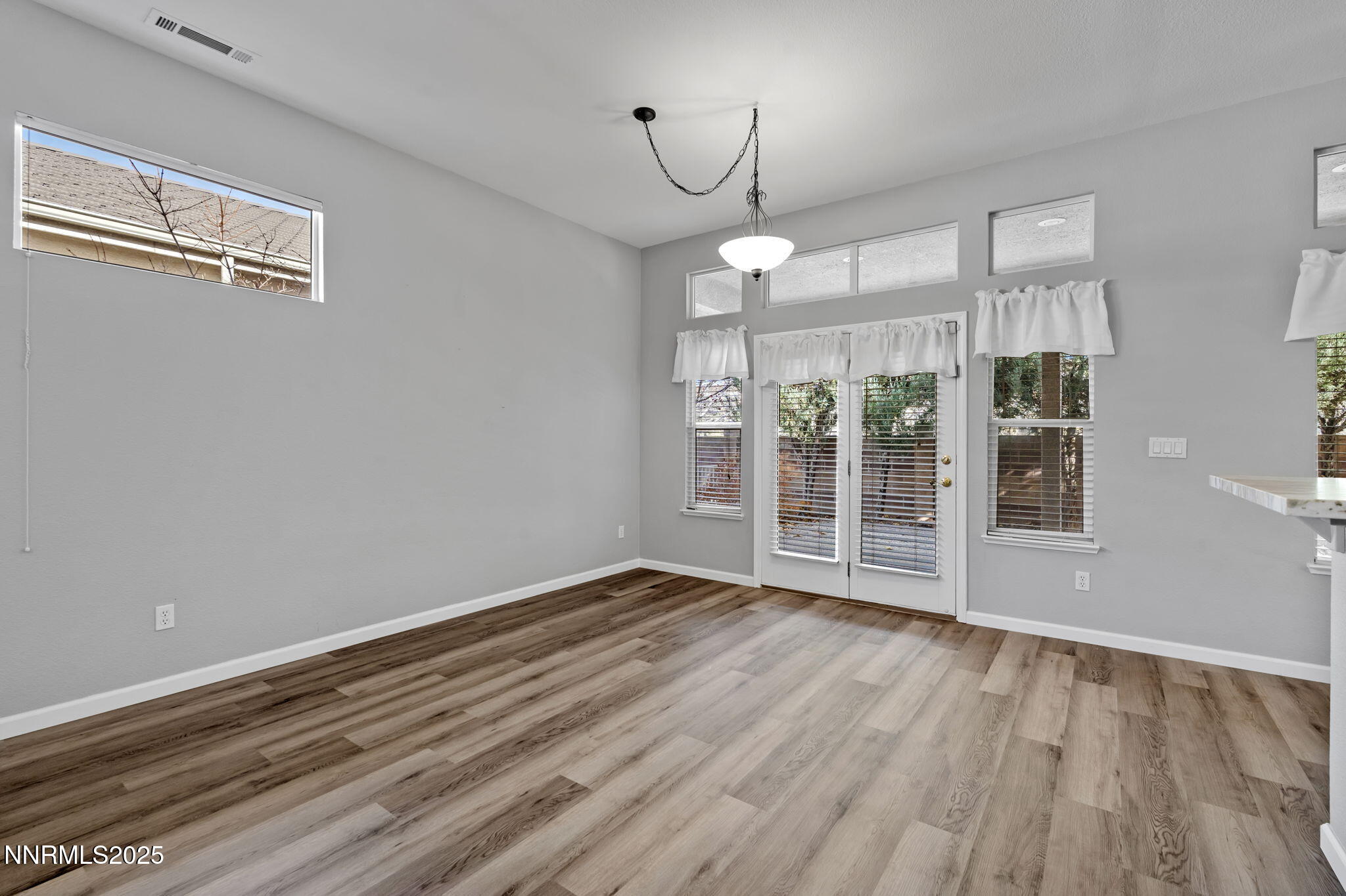 412 Sierra Leaf Circle Reno, NV 89511 - Photo 12 of 36 a view of an empty room with wooden floor and a window