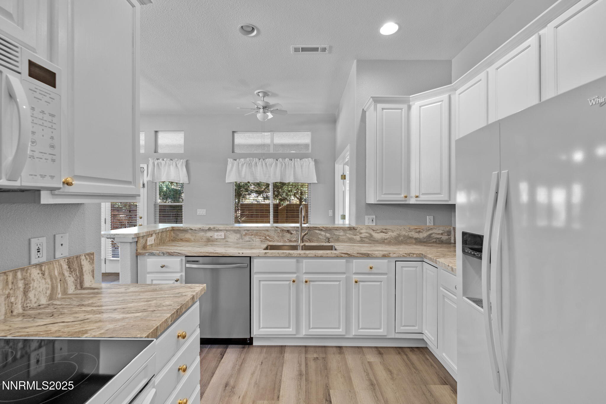 412 Sierra Leaf Circle Reno, NV 89511 - Photo 15 of 36 a kitchen with stainless steel appliances granite countertop a sink stove and refrigerator