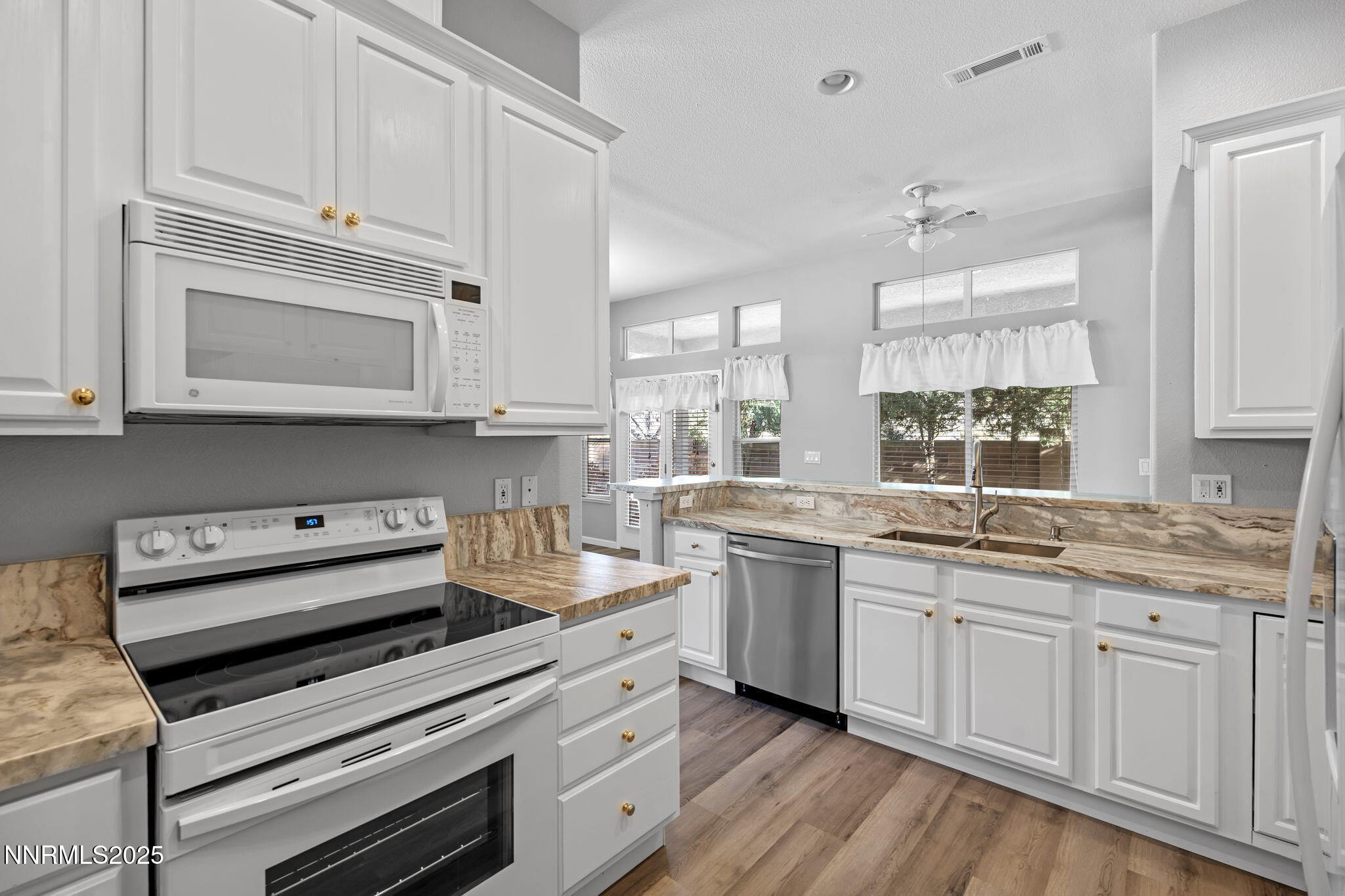412 Sierra Leaf Circle Reno, NV 89511 - Photo 16 of 36 a kitchen with appliances a sink and cabinets