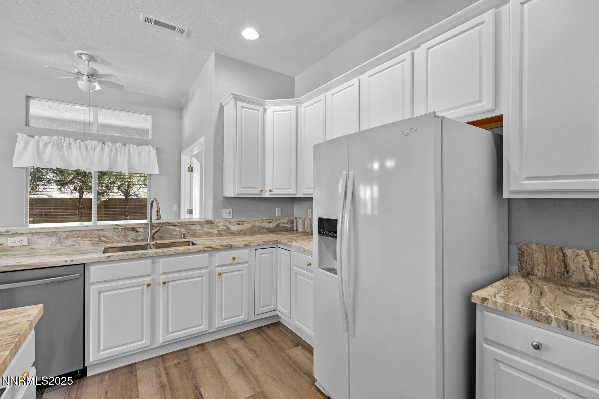 412 Sierra Leaf Circle Reno, NV 89511 - Photo 19 of 36 a kitchen with a sink a cabinets and window