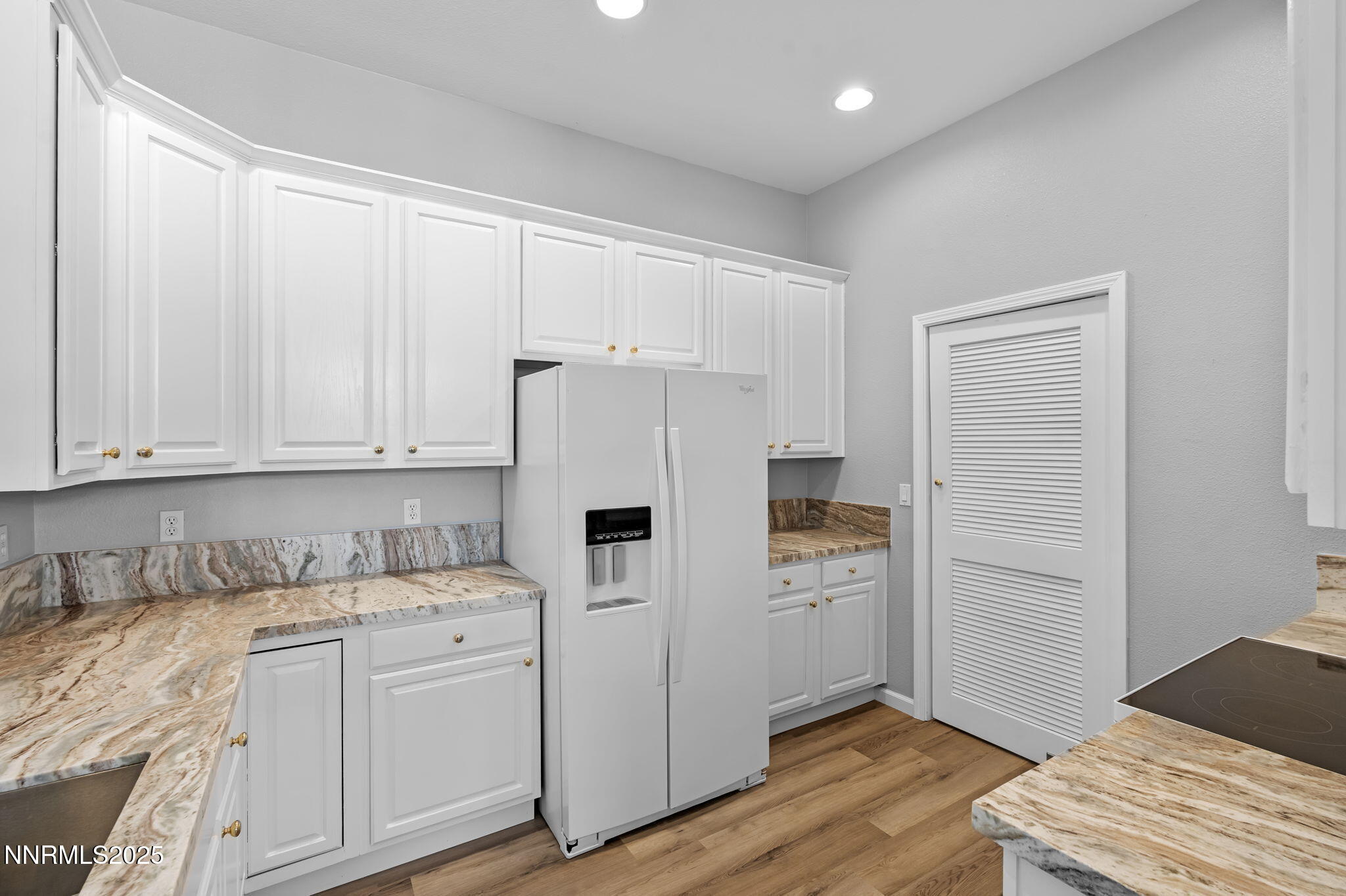 412 Sierra Leaf Circle Reno, NV 89511 - Photo 20 of 36 a kitchen with white cabinets and white appliances