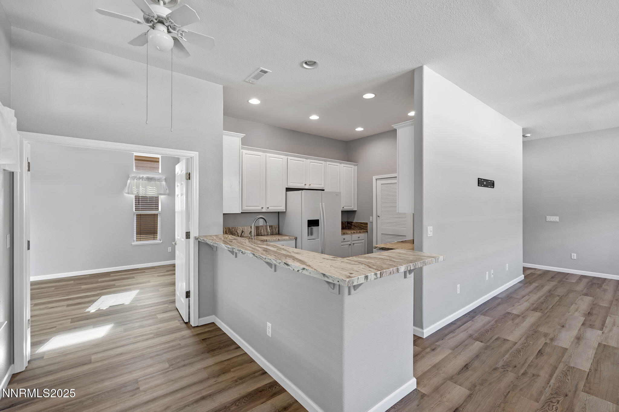 412 Sierra Leaf Circle Reno, NV 89511 - Photo 21 of 36 a kitchen with white cabinets and refrigerator