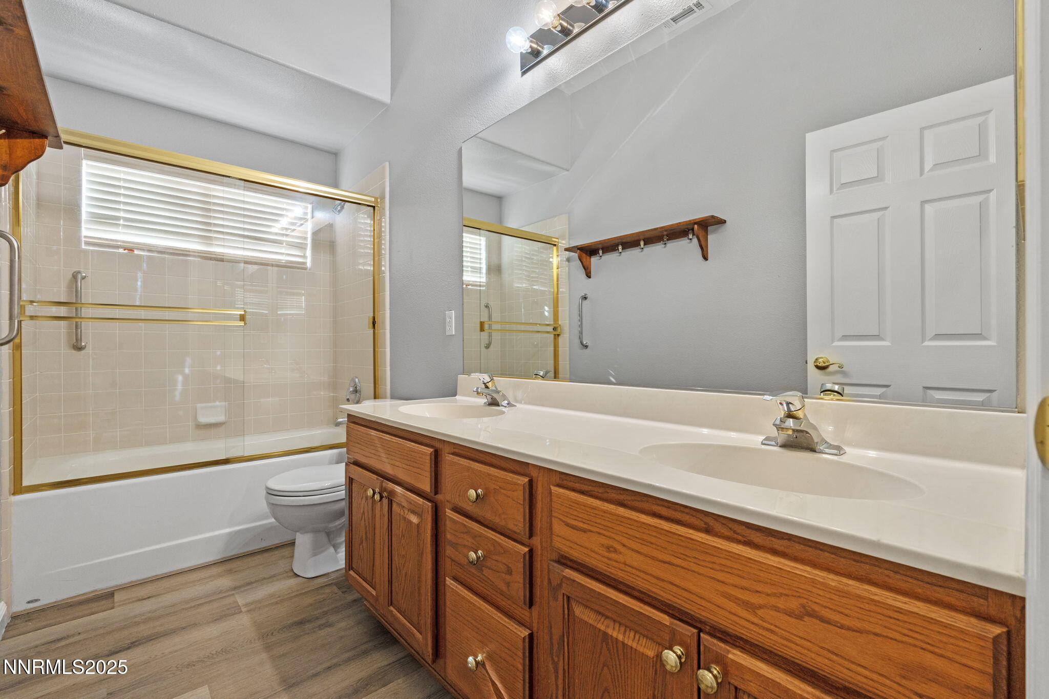 412 Sierra Leaf Circle Reno, NV 89511 - Photo 27 of 36 a bathroom with a double vanity sink toilet mirror and bathtub
