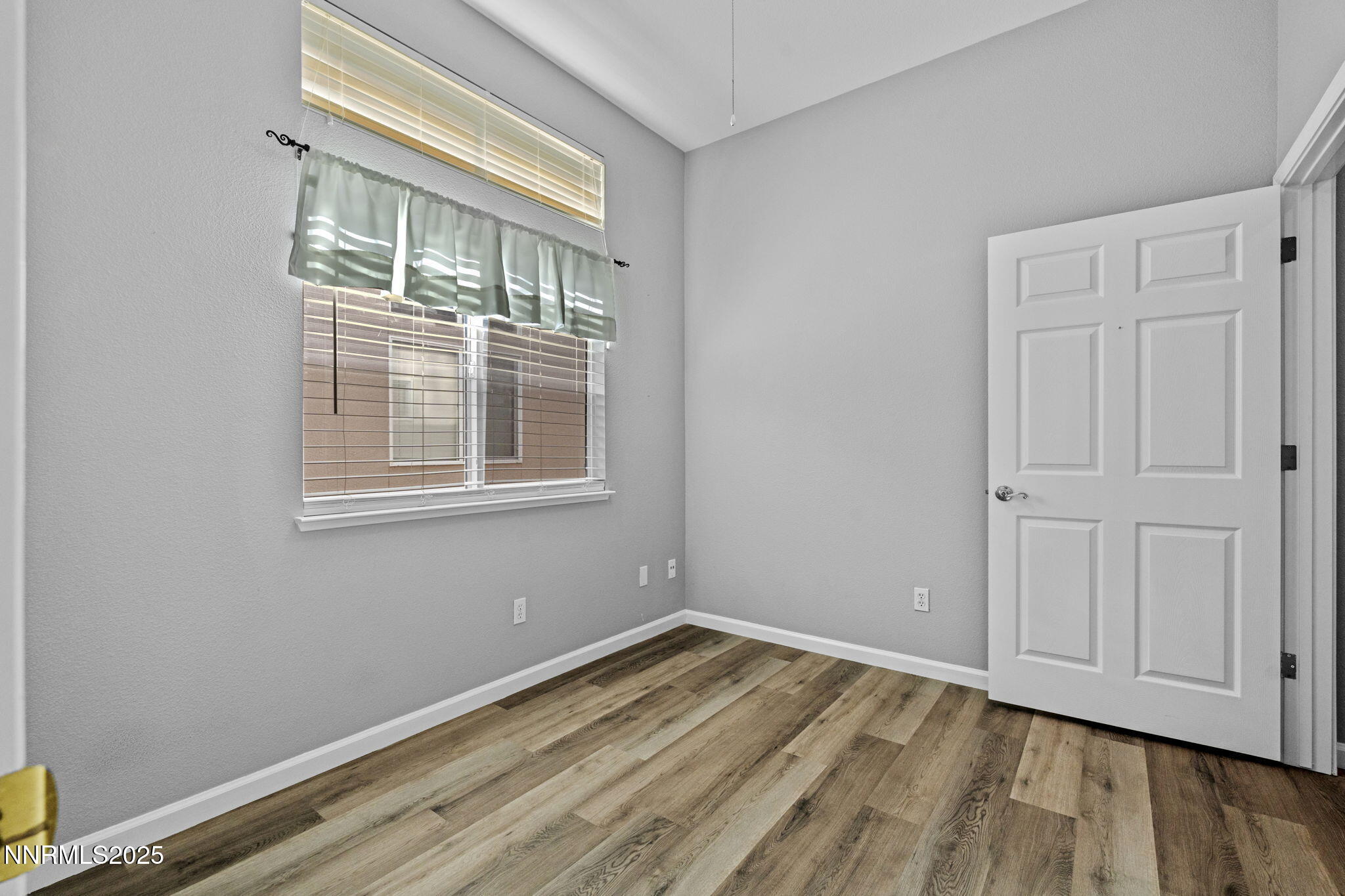 412 Sierra Leaf Circle Reno, NV 89511 - Photo 29 of 36 a view of empty room with wooden floor and fan