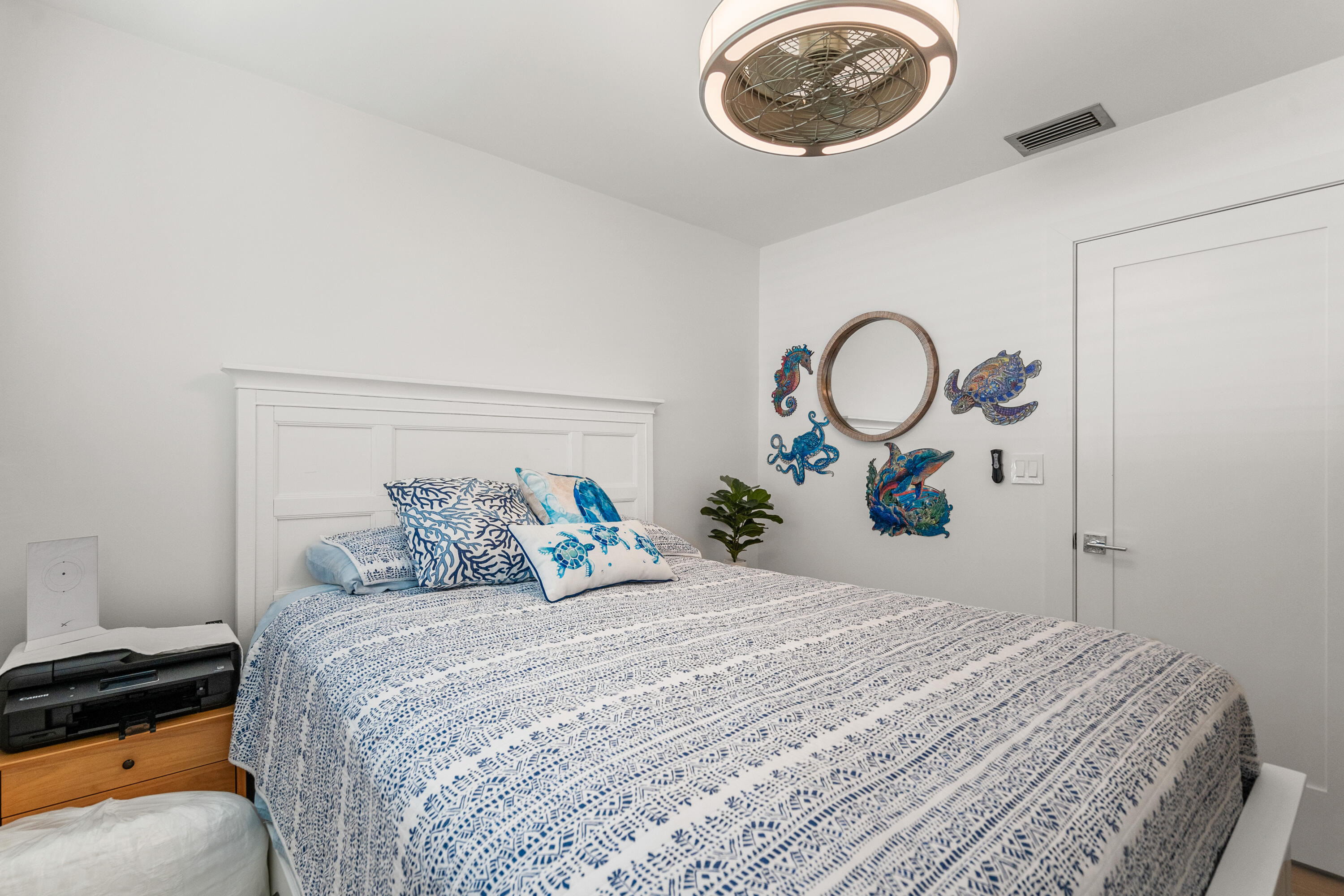 114 Spoonbill Road Tavernier, FL 33070 - Photo 24 of 43 a bedroom with a bed and a lamp on dresser