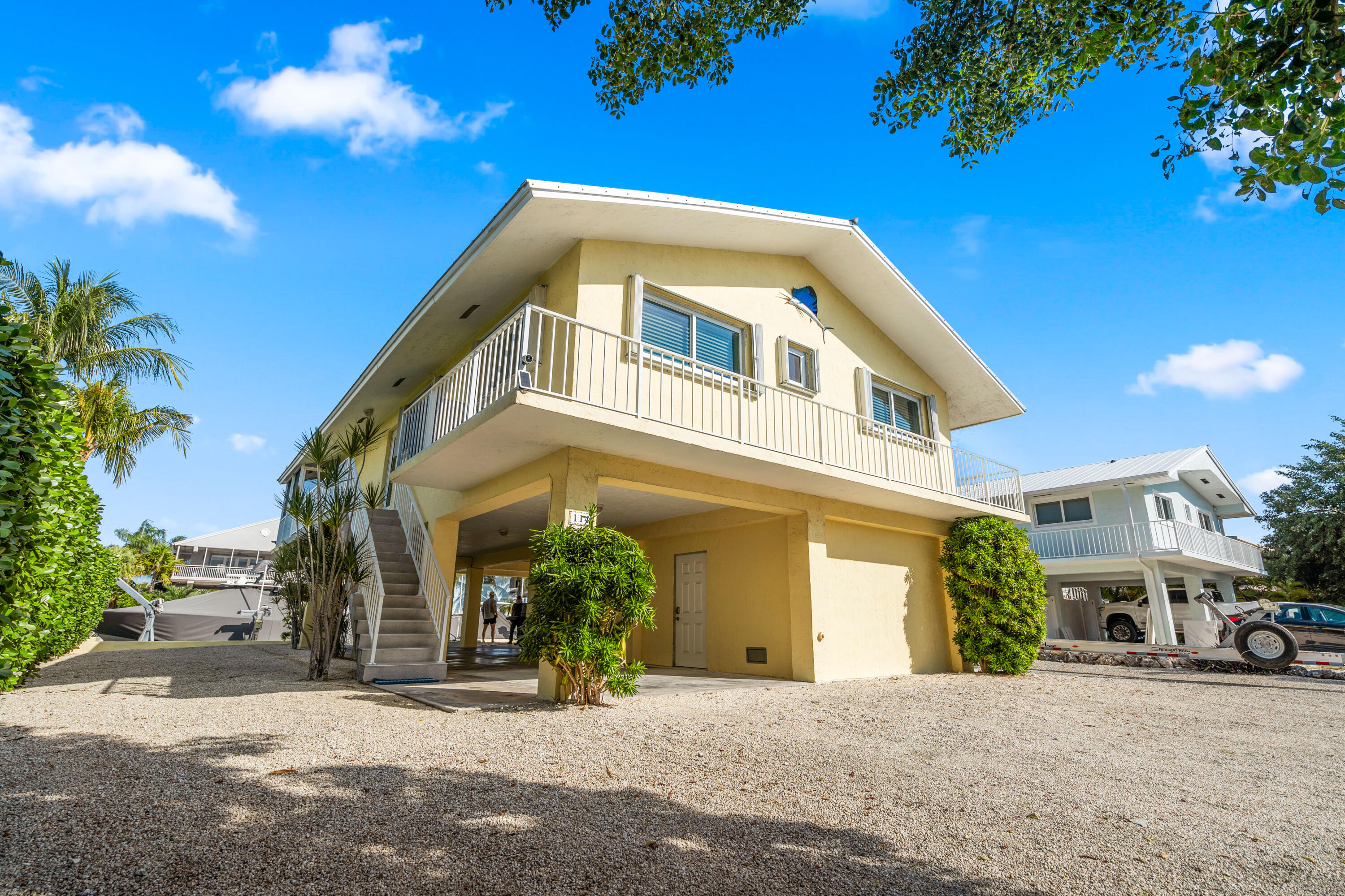 114 Spoonbill Road Tavernier, FL 33070 - Photo 37 of 43 a front view of a building with a yard