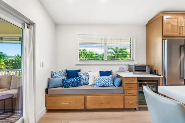 a large kitchen with a table chairs stove and wooden floor
