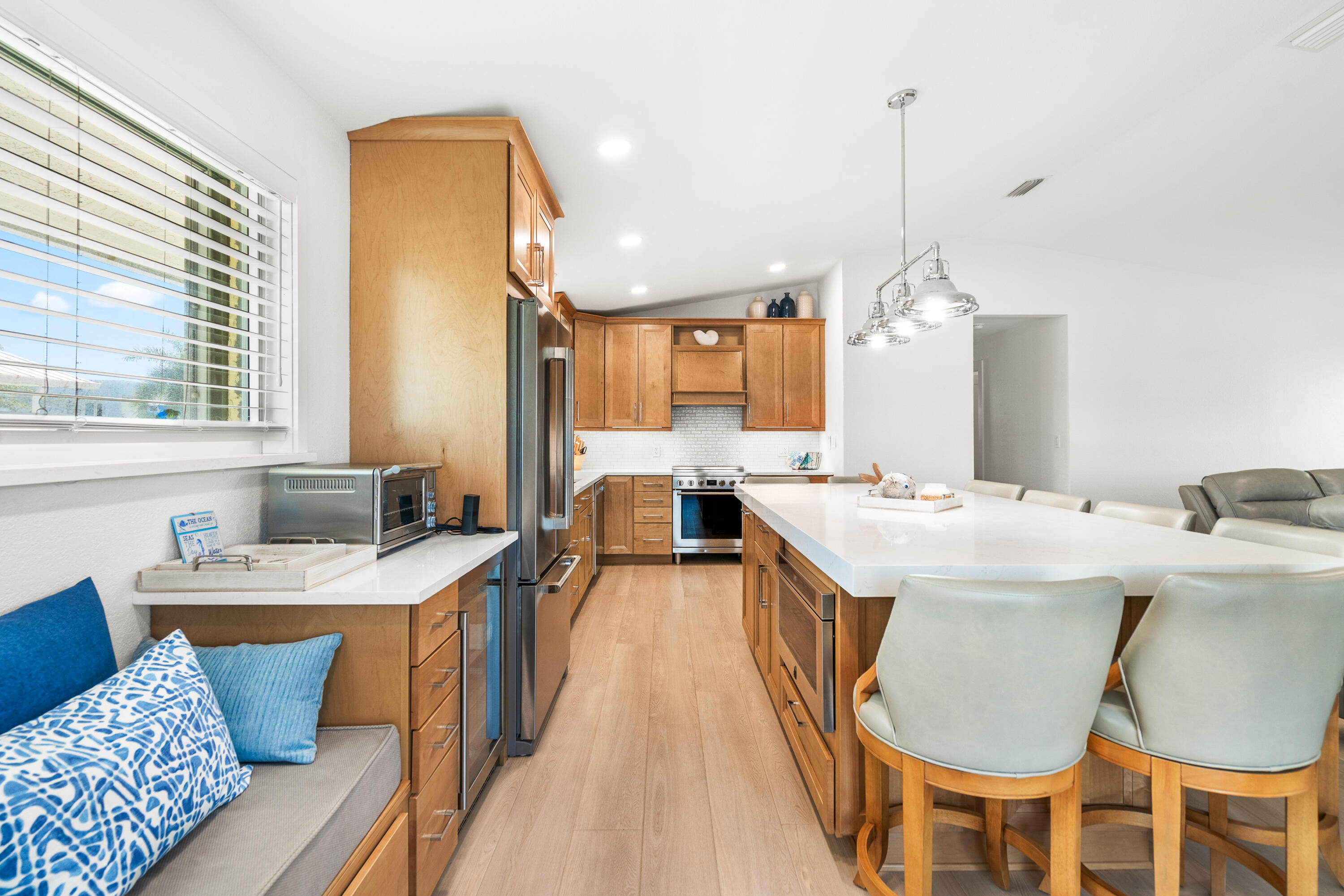 114 Spoonbill Road Tavernier, FL 33070 - Photo 9 of 43 a large kitchen with a table chairs stove and wooden floor