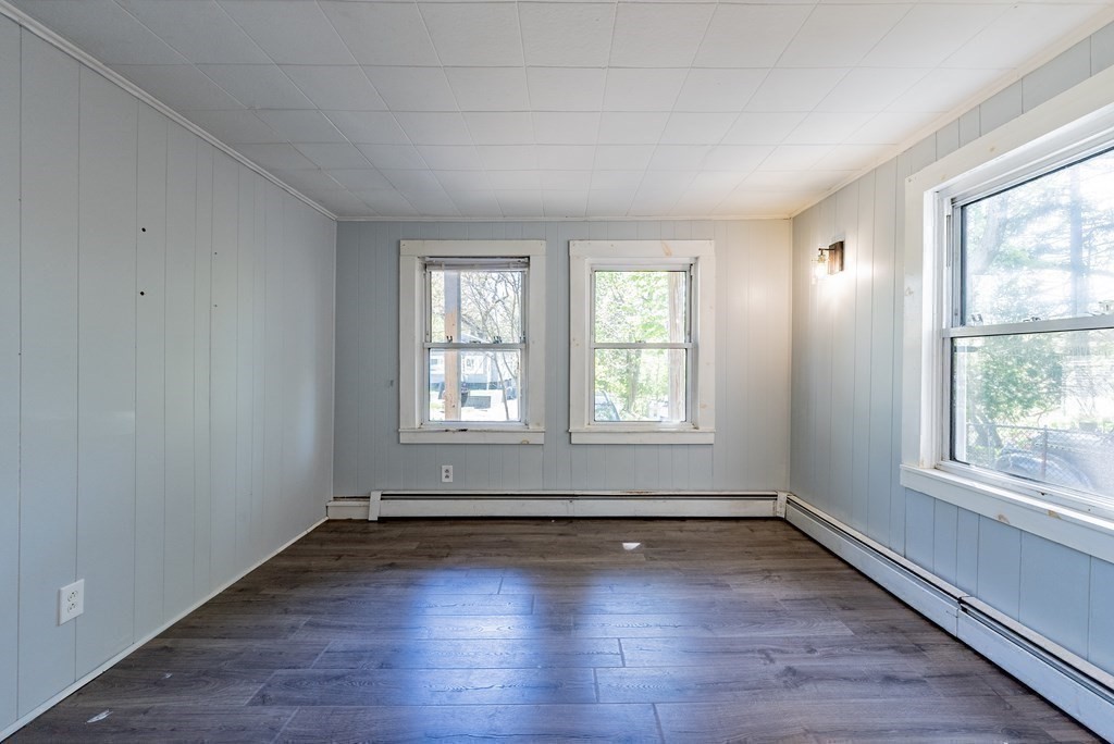 272 Denver Street Springfield, MA 01109 - Photo 13 of 32 an empty room with wooden floor and windows
