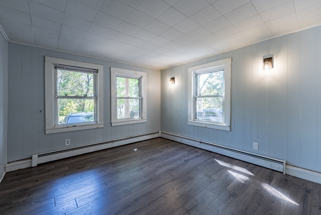 272 Denver Street Springfield, MA 01109 - Photo 14 of 32 an empty room with wooden floor and windows