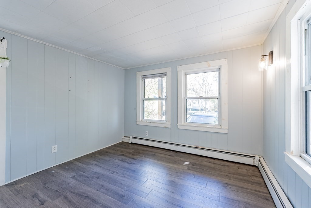272 Denver Street Springfield, MA 01109 - Photo 15 of 32 an empty room with wooden floor and windows