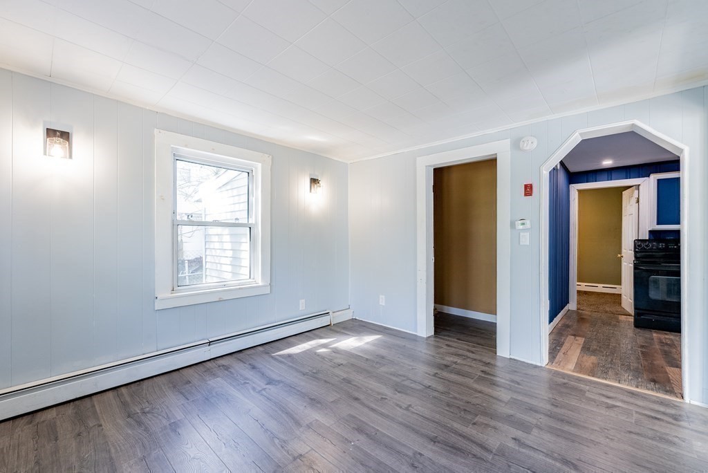 272 Denver Street Springfield, MA 01109 - Photo 16 of 32 an empty room with wooden floor and windows