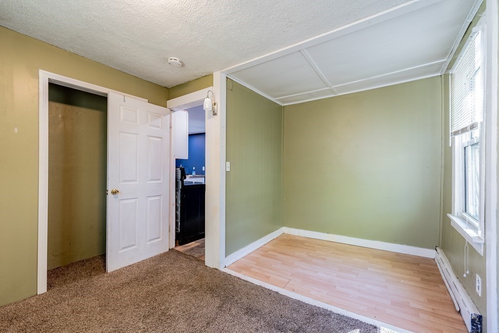 272 Denver Street Springfield, MA 01109 - Photo 18 of 32 a view of empty room with wooden floor and fan
