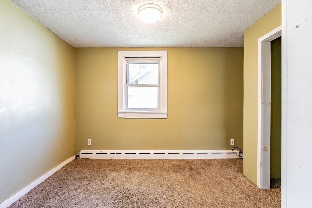 272 Denver Street Springfield, MA 01109 - Photo 20 of 32 an empty room with a window