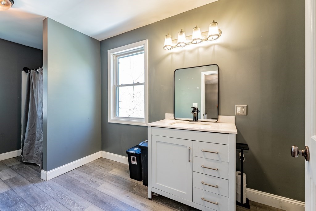 272 Denver Street Springfield, MA 01109 - Photo 7 of 32 a bathroom with a granite countertop sink a mirror and a vanity