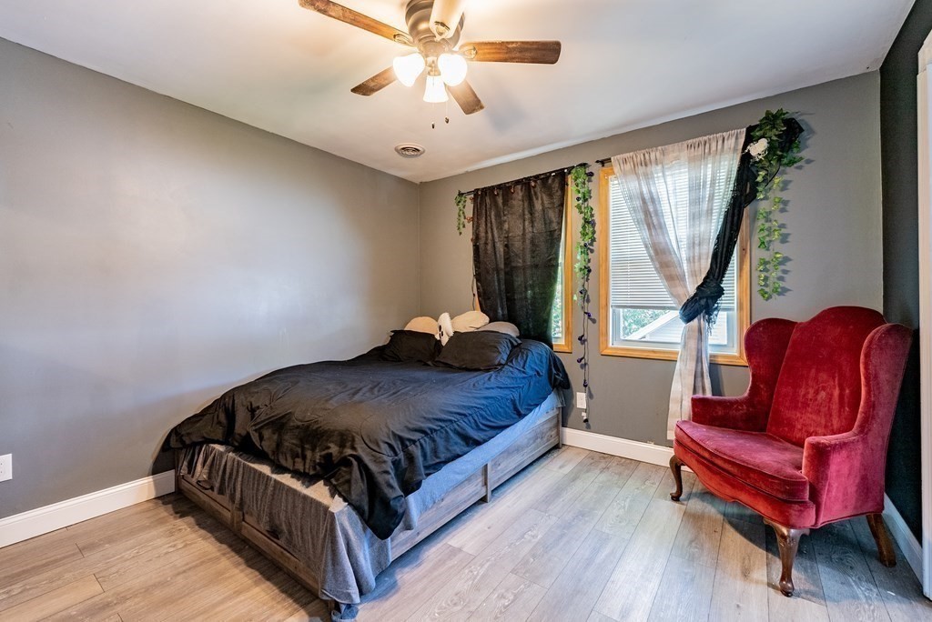 272 Denver Street Springfield, MA 01109 - Photo 10 of 32 a bedroom with a bed and wooden floor