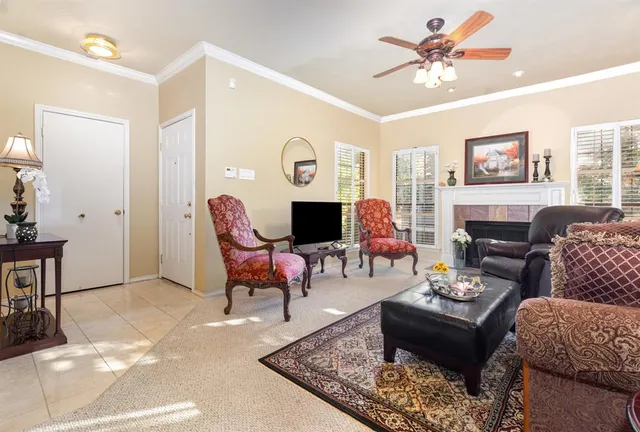 a living room with furniture fireplace and a window