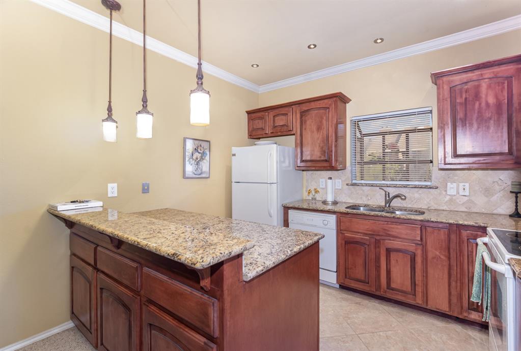 5859 Frankford Road, Unit 802 Dallas, TX 75252 - Photo 14 of 33 a kitchen with a sink refrigerator and cabinets