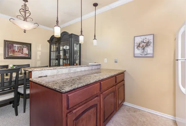 a kitchen with a counter space cabinets and wooden floor