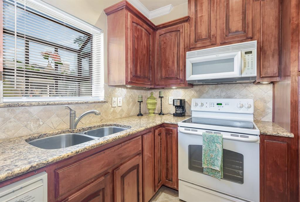 5859 Frankford Road, Unit 802 Dallas, TX 75252 - Photo 17 of 33 a kitchen with granite countertop a sink stove and cabinets