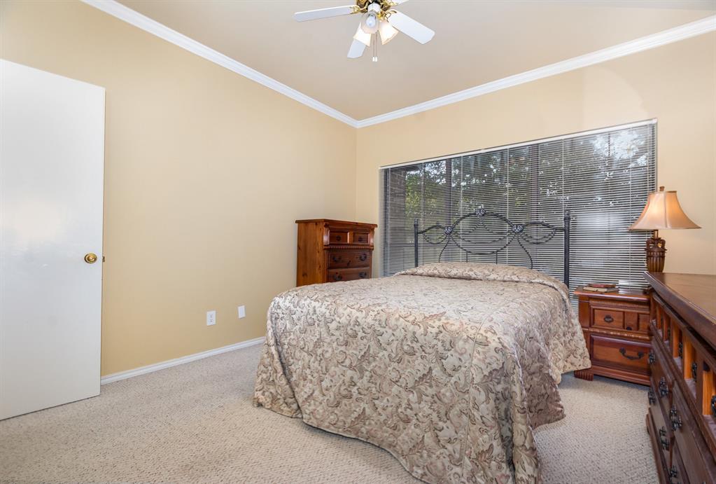5859 Frankford Road, Unit 802 Dallas, TX 75252 - Photo 26 of 33 a bedroom with a bed and a chandelier