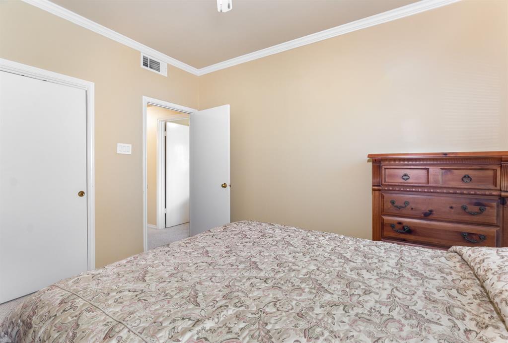 5859 Frankford Road, Unit 802 Dallas, TX 75252 - Photo 27 of 33 a bedroom with a bed and a dresser