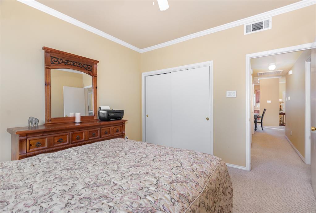 5859 Frankford Road, Unit 802 Dallas, TX 75252 - Photo 28 of 33 a bedroom with a bed and a dresser