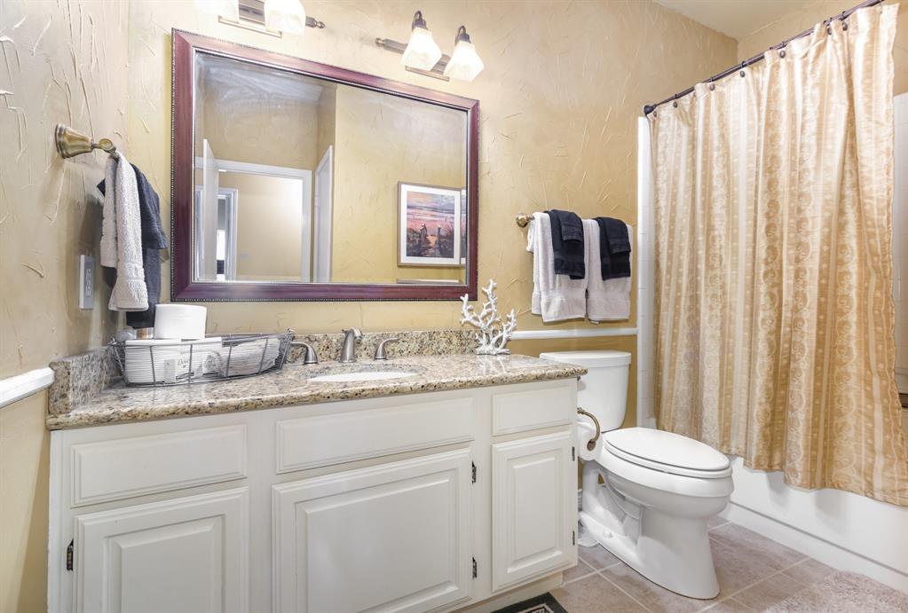 5859 Frankford Road, Unit 802 Dallas, TX 75252 - Photo 29 of 33 a bathroom with a granite countertop toilet sink and mirror