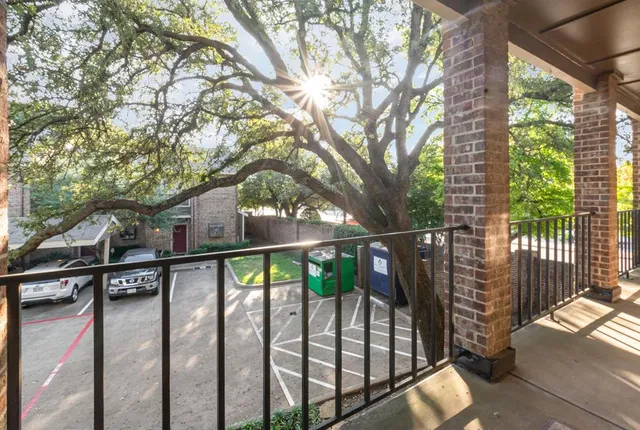 a view of balcony with wooden floor and fence