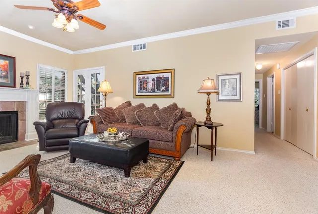 a living room with furniture a rug and a chandelier