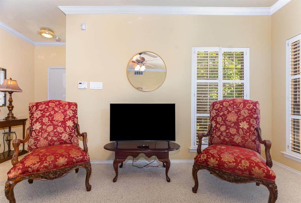 5859 Frankford Road, Unit 802 Dallas, TX 75252 - Photo 8 of 33 a living room with furniture a flat screen tv and a fireplace